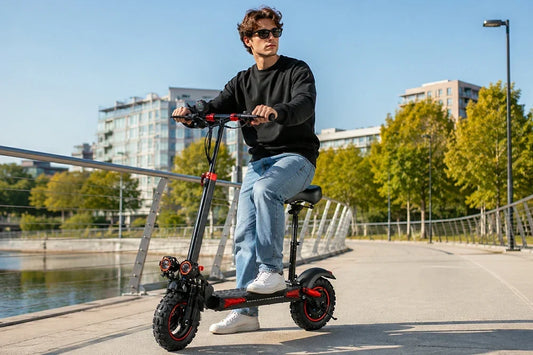 Man riding Freeboy J11 MAX electric scooter on city riverside promenade, bright sunny urban scenery
