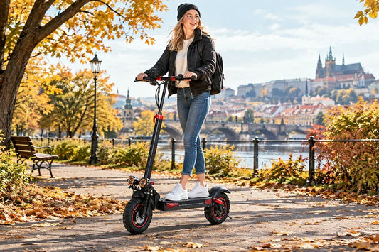 Woman riding Freeboy J11 Max electric scooter on autumn riverside path with Prague castle view