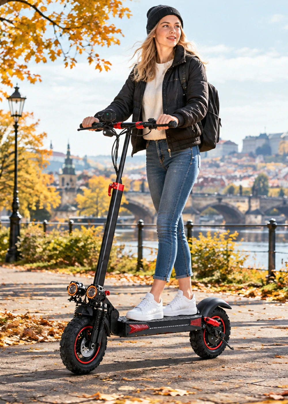 Woman riding Freeboy J11 Max electric scooter on autumn riverside path in Prague.